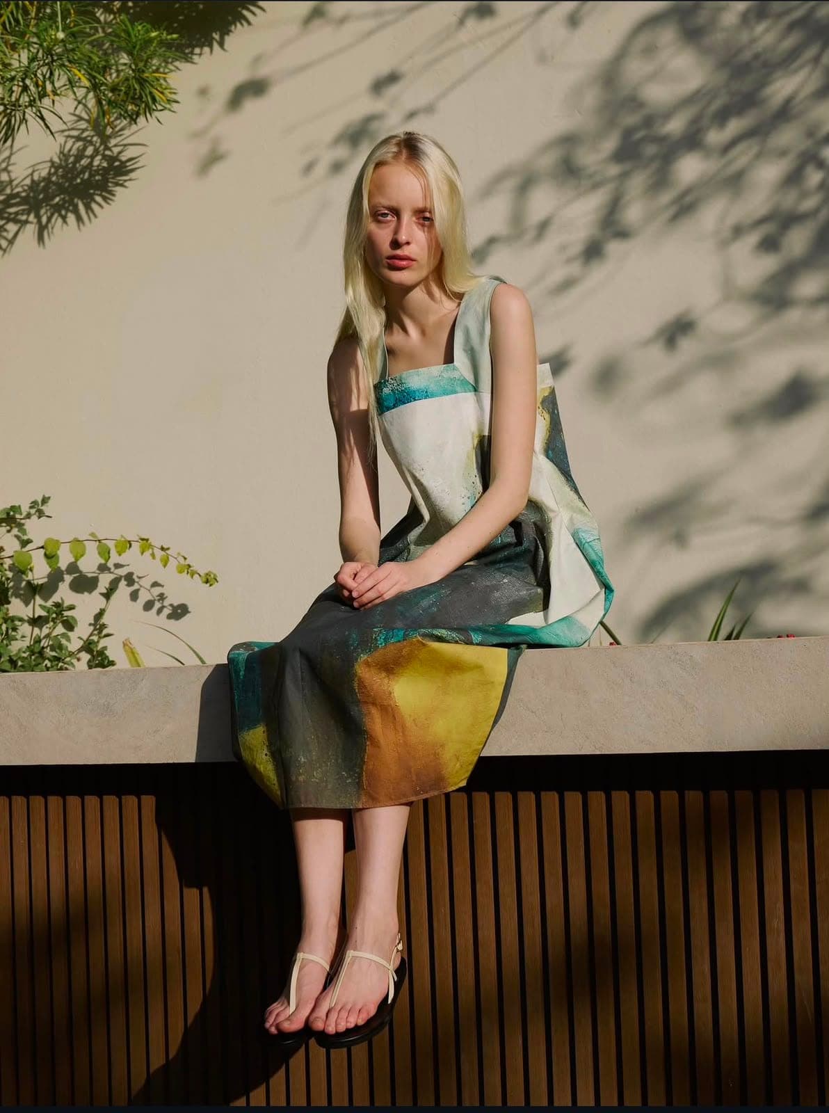 Hand-painted fabric worn like a canvas — JAĀME in afternoon light.