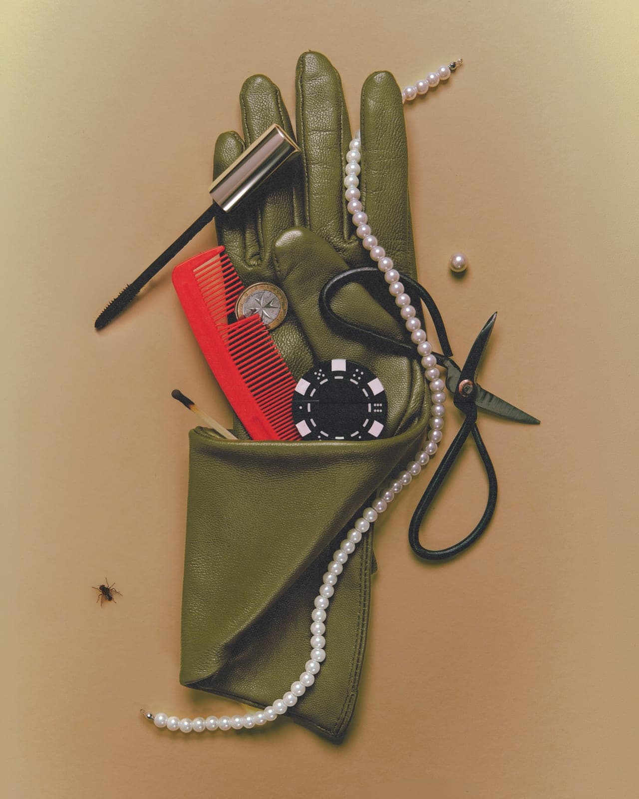 A leather glove and small objects, arranged with intent.